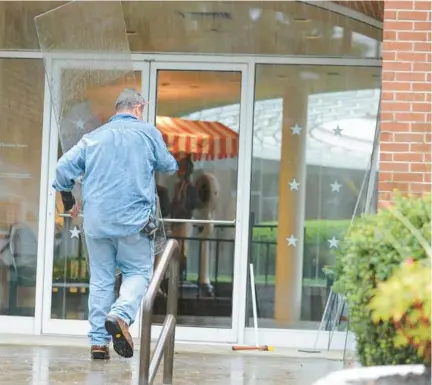  ?? LORI VAN BUREN/ALBANY TIMES UNION ?? A worker replaces a door Sept. 13, 2013, at the National Museum of Racing and Hall of Fame in Saratoga Springs, N.Y.