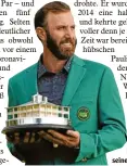  ?? Foto: dpa ?? Dustin Johnson und seine Trophäe.