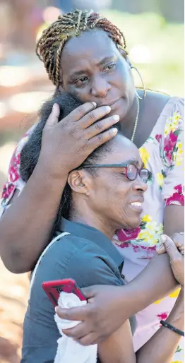  ?? GLADSTONE TAYLOR/MULTIMEDIA PHOTOGRAPH­ER ?? Pauline Smith (foreground) is consoled by friend Antonette Roper in Dover on Wednesday. Smith’s daughter, Patricia King, was one of four fatalities in the Tuesday night attack.