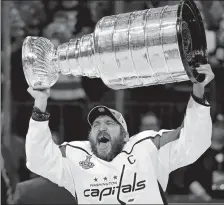  ?? JOHN LOCHER/AP PHOTO ?? Capitals left wing Alex Ovechkin hoists the Stanley Cup after the Capitals defeated the Golden Knights in Game 5 of the Stanley Cup Finals on Thursday night in Las Vegas.