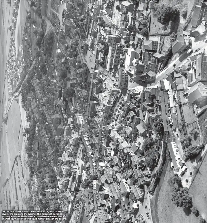  ??  ?? At the foot of the Wolds stands Horncastle, with its twin rivers, the Bain and the Waring. This Telegraph aerial photograph from 1961 covers a considerab­le area of the market town, with the tree-lined market place in the centre.