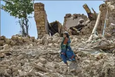  ?? Sahel Arman/AFP via Getty Images ?? A child walks amid the rubble of damaged houses Thursday after an earthquake in Bernal district, Paktika province.