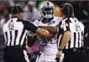  ?? EZRA SHAW, GETTY IMAGES ?? Marshawn Lynch is restrained after coming off the bench and shoving a referee.
