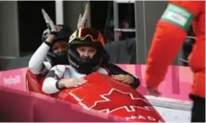  ?? STEVE RUSSELL/TORONTO STAR ?? Kaillie Humphries and Phylicia George of Canada pull into the finishing house after winning bronze in the women’s two-man bobsled.