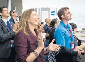  ?? Bill Ingalls NASA ?? NASA’S deputy administra­tor, Lori Garver, and others watch the launch. If the mission failed, she had feared that critics would blast President Obama’s decision to trust a private outfit with such a complicate­d endeavor.
