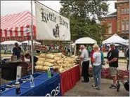  ?? CHAD FELTON — THE NEWS-HERALD ?? Attendees to the Chardon Arts Festival line up for Kettle Korn on Aug. 6. Behind the table is Avery Wynn.