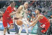  ?? AL DIAZ/MIAMI HERALD ?? Miami guard Bruce Brown (11) battles NC State guards Markell Johnson (11) and Terry Henderson (3) in Saturday’s 81-63 win in Coral Gables.