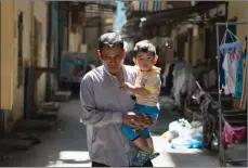  ?? PICTURE: TODD BROWN ?? Din Savorn, 50, carries his son to daycare in Phnom Penh, Cambodia. In 2016, MSF set up a treatment clinic for patients with hepatitis C in Preah Kossamak Hospital in Phnom Penh.