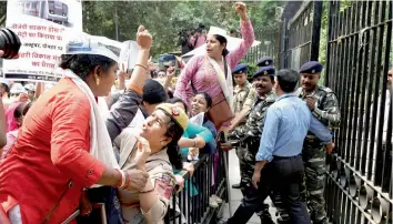  ?? — PTI ?? AAP workers shout slogans during a protest over Metro fare hike outside the urban developmen­t ministry, Nirman Bhavan, in New Delhi on Friday.