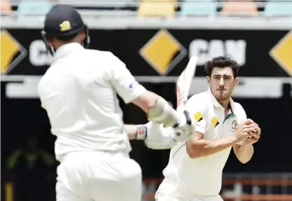  ??  ?? AUSTRALIA : This picture taken on November 9, 2015 shows Australia’s paceman Mitchell Starc (R) throwing a ball towards New Zealand’s batsman Mark Craig. The Internatio­nal Cricket Council fined Australia paceman Mitchell Starc half of his match fee for...