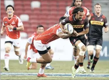  ??  ?? Dillyn Leyds (right) of the Stormers is tackled by Shota Emi of the Sunwolves during the Super Rugby match at the National Stadium in Singapore yesterday. WYNONA LOUW