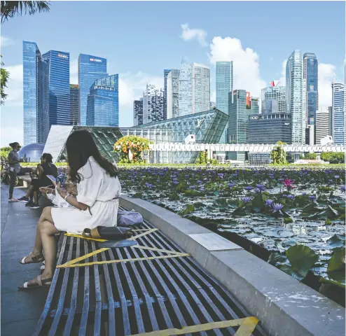  ?? ROSLAN RAHMAN / AFP VIA GETTY IMAGES ?? Expats under 40 were at the end of the vaccinatio­n queue in Singapore, with bookings opened to expats last week.