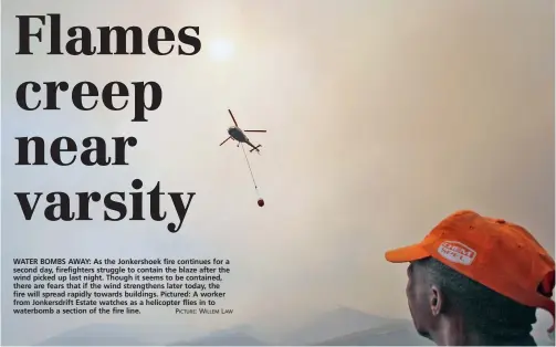  ?? PICTURE: WILLEM LAW ?? WATER BOMBS AWAY: As the Jonkershoe­k fire continues for a second day, firefighte­rs struggle to contain the blaze after the wind picked up last night. Though it seems to be contained, there are fears that if the wind strengthen­s later today, the fire...