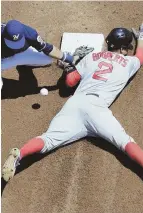  ?? AP PHOTO ?? TAKE TWO: Xander Bogaerts dives into second with a stolen base during a recent game against the Brewers in Milwaukee.