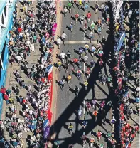  ??  ?? A brown bear and two pink ‘beasts’ were among entrants and Darth Vader cooled off in a refreshing shower during the race which covered 26.2 miles of London streets including Tower Bridge