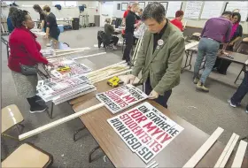  ?? Arkansas Democrat-Gazette/JEFF GAMMONS ?? Josh McCalliste­r, a teacher at Fulbright Elementary School, helps make signs Wednesday at the Arkansas Education Associatio­n building near the state Capitol for today’s one-day strike by Little Rock teachers and support staff.