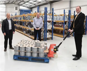  ??  ?? > From left: Ian Jones and Ed Feathersto­ne from H&S Electrical Wholesaler­s in the company’s Brierley Hill warehouse, with Fisher German surveyor Luke Dodge