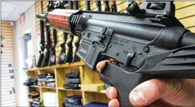  ?? ASSOCIATED PRESS ?? Agunshop employee demonstrat­es a “bump” stock. The LasVegas gunmanwho fired hundreds of rounds Sunday attached the device to two of hisweapons.