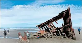  ??  ?? The bare bones of the Peter Iredale, a British four-masted bark that ran aground in 1906, are a magnet for beach visitors to Fort Stevens State Park.