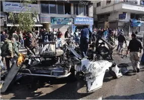  ?? AFP ?? The site of a car bomb explosion in a predominan­tly pro-Assad neighbourh­ood in the central Syrian city of Homs on Tuesday