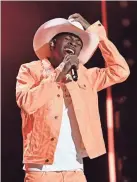  ??  ?? Lil Nas X performs during the CMA Fest on June 8 in Nashville. LARRY MCCORMACK /USA TODAY NETWORK - TENNESSEE