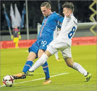  ?? Picture: AFP ?? TURNING UP THE HEAT: Iceland's midfielder Gylfi Sigurdsson, left, and Kosovo's Besar Halimi tussle for the ball during their World Cup qualifying match on Monday. The Icelanders came through smiling