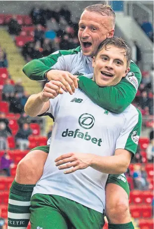  ?? SNS. ?? James Forrest, above, is congratula­ted by Leigh Griffiths after scoring his fourth – and Celtic’s fifth goal; right: Forrest beats Zander Clark for his second; far right: Saints players are downbeat after Celtic’s sixth.