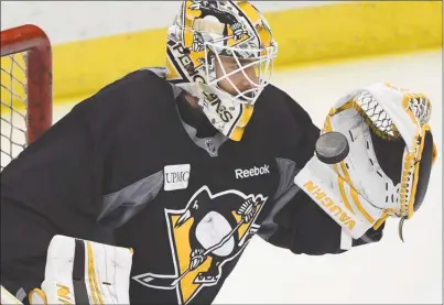  ?? The Associated Press ?? Pittsburgh Penguins goaltender Matt Murray catches the puck during practice on Wednesday at PPG Paints Arena in Pittsburgh.