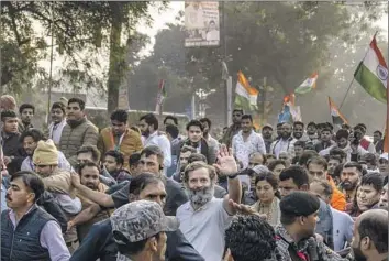  ?? Altaf Qadri Associated Press ?? RAHUL GANDHI, waving, leader of the Indian National Congress, greets supporters last month on his cross-country walk. Gandhi accuses Prime Minister Narendra Modi of using religion to divide the country.