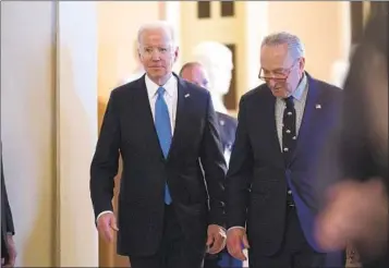  ?? J. SCOTT APPLEWHITE AP ?? President Joe Biden (left) and Senate Majority Leader Chuck Schumer, D-N.Y., arrive to talk to reporters after a lunch with Senate Democrats on his upcoming budget and political agenda Thursday in Washington.