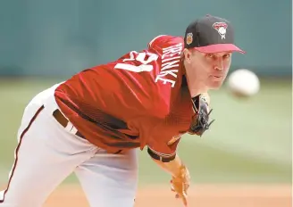  ??  ?? Arizona Diamondbac­ks’ Zack Greinke warms up prior to a spring training baseball game against the Chicago Cubs in Scottsdale, Ariz., Thursday.