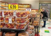  ?? JUSTIN SULLIVAN/GETTY IMAGES/TNS ?? A customer shops for food at a grocery store March 12 in San Rafael, Calif.