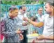  ?? PTI ?? A man offers sweets to the convicts after they were released from Godhra sub-jail on August 15.