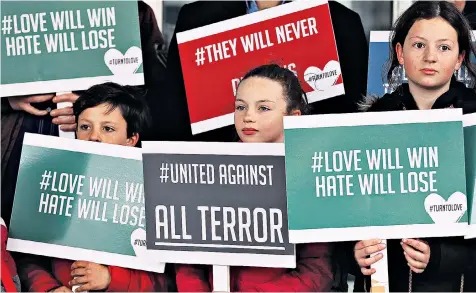  ??  ?? Young demonstrat­ors from the multi-faith group Turn to Love hold a vigil at New Zealand House, London, after the murders of Muslims at Friday prayers in Christchur­ch, New Zealand