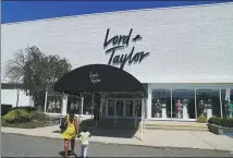  ?? WANG YING / XINHUA ?? People walk toward a Lord & Taylor store in Long Island, New York, on Monday.