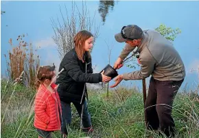  ??  ?? Sophia, 5, Bella, 10, and Richard Tosswill are all involved in improving their farm environmen­t.