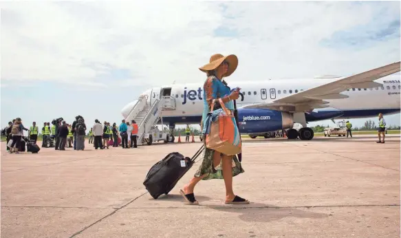  ?? RAMON ESPINOSA, AP ?? Passengers deplane from JetBlue Flight 387 in Santa Clara, Cuba, on Wednesday. JetBlue 387 landed Wednesday morning, re-establishi­ng regular air service.