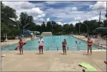  ?? PHOTO COURTESY OF LANSDALE PARKS AND RECREATION ?? Lifeguards wear masks and stand six feet apart on the deck of Fourth Street Pool in Lansdale on the first day of the pool’s abbreviate­d 2020 season on Wednesday.