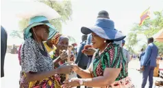  ?? ?? First Lady Dr Auxillia Mnangagwa interacts with the elderly while handing them food hampers and mealie meal in Mbire yesterday.
