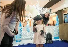  ??  ?? Willow Canning, 4, dons the virtual reality goggles, ready for a snowball battle.