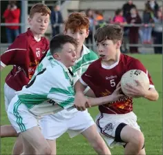  ??  ?? Jack O’Gorman of Castletown comes under pressure from Matthew Bishop (Crossabeg-Ballymurn).