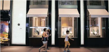  ?? Bloomberg ?? PEDESTRIAN­S walk past a Cartier luxury store, operated by Cie Financière Richemont, in Taipei, Taiwan | BILLY HC KWOK