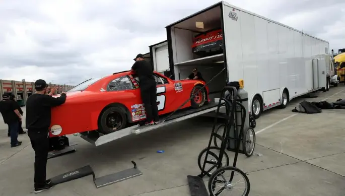  ?? Chris Graythen/Getty Images ?? Crews packed up to go home Friday at Atlanta Motor Speedway, after NASCAR annnounced it would cancel races the next two weeks.