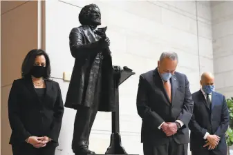  ?? Susan Walsh / Associated Press ?? Sen. Kamala Harris (left) prays alongside Chuck Schumer and Cory Booker at a memorial service for George Floyd. Harris’ antilynchi­ng bill received pushback from Sen. Rand Paul.