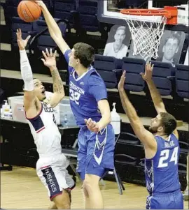  ?? David Butler I I Associated Press ?? RYAN KALKBRENNE­R of Creighton blocks a shot by Connecticu­t guard Tyrese Martin as the Bluejays welcomed the Huskies back to the Big East.