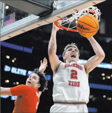  ?? Ashley Landis
The Associated Press ?? Alabama forward Grant Nelson dunks past Clemson forward Ian Schieffeli­n on Saturday in Los Angeles during a second half that saw the Crimson Tide bury 10 3-pointers to secure an 89-82 victory.