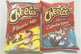  ?? KELMAN, THE COMMERCIAL APPEAL BRETT ?? Flaming' Hot Cheetos and Takis tortilla chips are intensely spicy snacks that doctors say are causing abdominal pains in hundreds of Memphis kids.