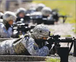  ?? Mark Humphrey Associated Press ?? FEMALE SOLDIERS practice on a firing range in Ft. Campbell, Ky. The Army’s Special Operations Command has released a new report on issues women face.