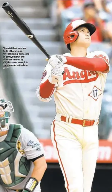  ?? GETTY ?? Shohei Ohtani watches flight of home run in seventh inning, his second of game, but that and five more homers by Angels are not enough to overcome A’s in Anaheim.