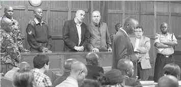  ??  ?? JAIL FOR LIFE: Sayed Mousavi (centre left) and Ahmad Mohammed (centre right) stand at the dock during sentencing at the Kenyan High Court in Nairobi. — Reuters photo